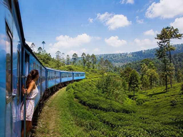 Blue train winding through Sri Lankan tea country hills